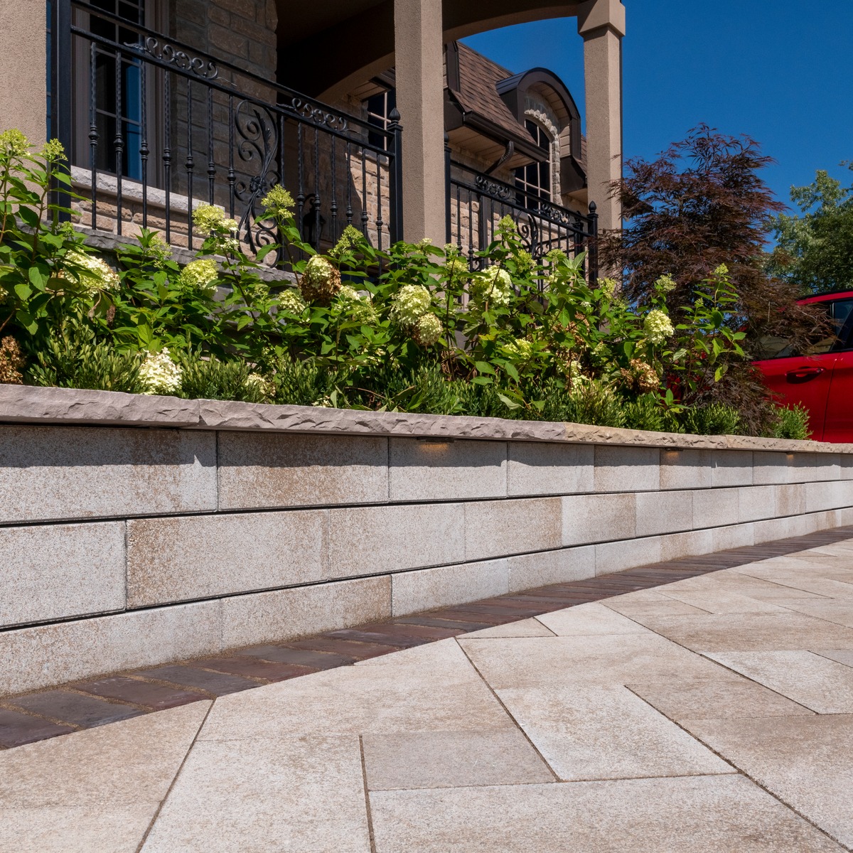 low garden retaining wall with flowers