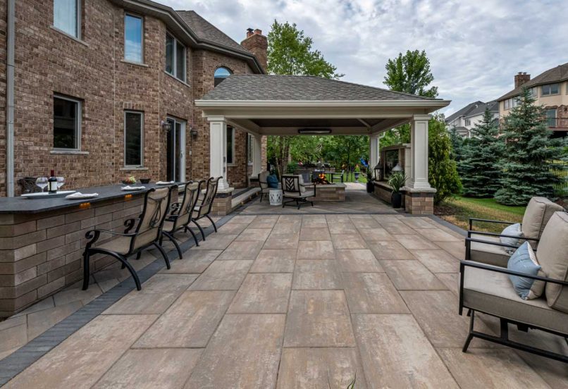 Outdoor Living Space with Kitchen Bar Table and Fire Pit and TV Wall